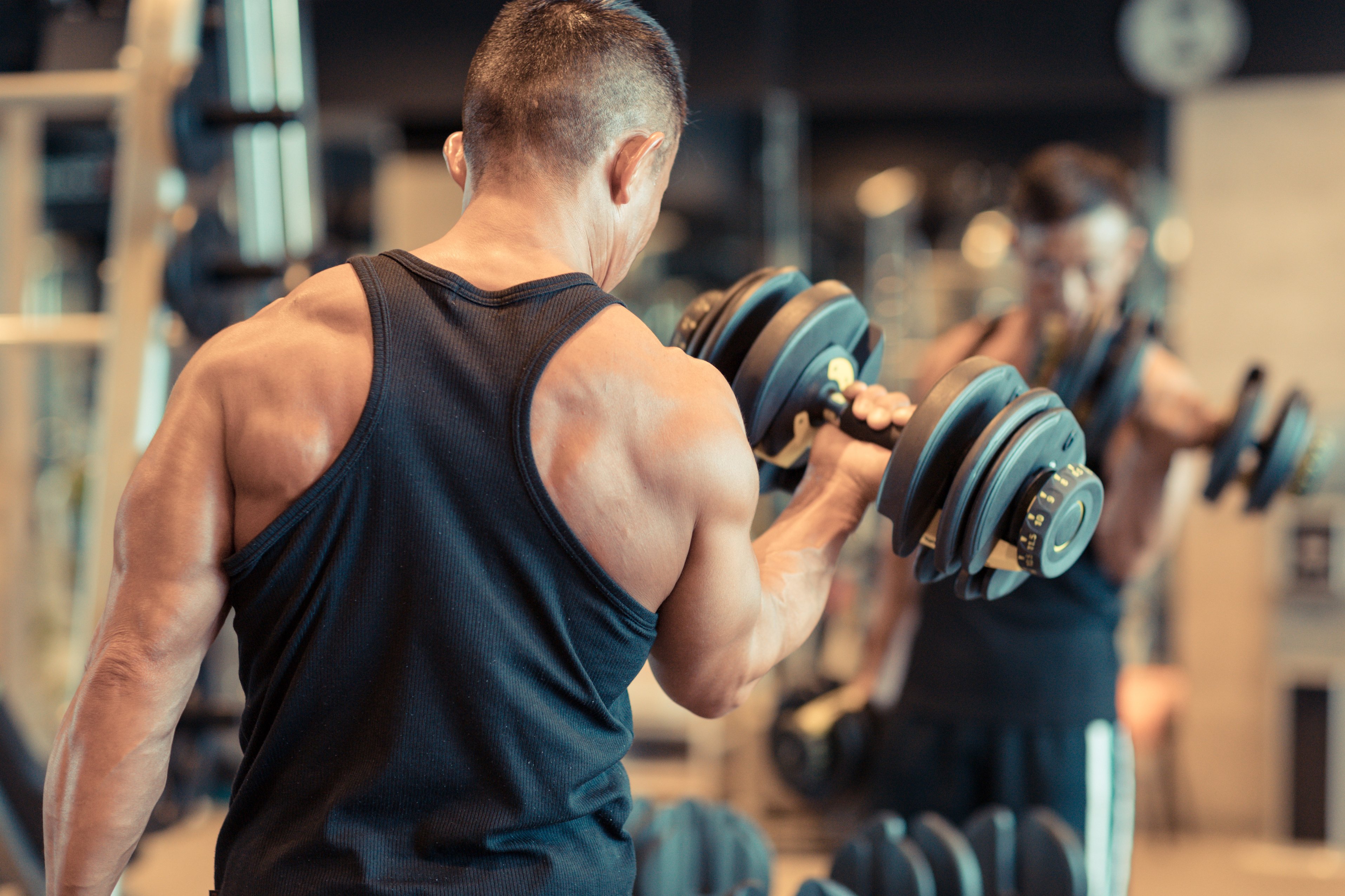 Mature man doing training in personal training gym